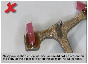 Messy application of shellac. Shellac should not be present on the body of the pallet fork or on the sides of the pallet arms.